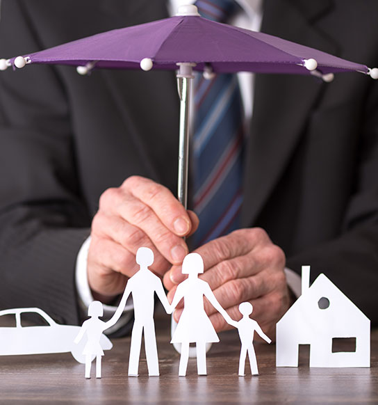 Man holding umbrella over paper family